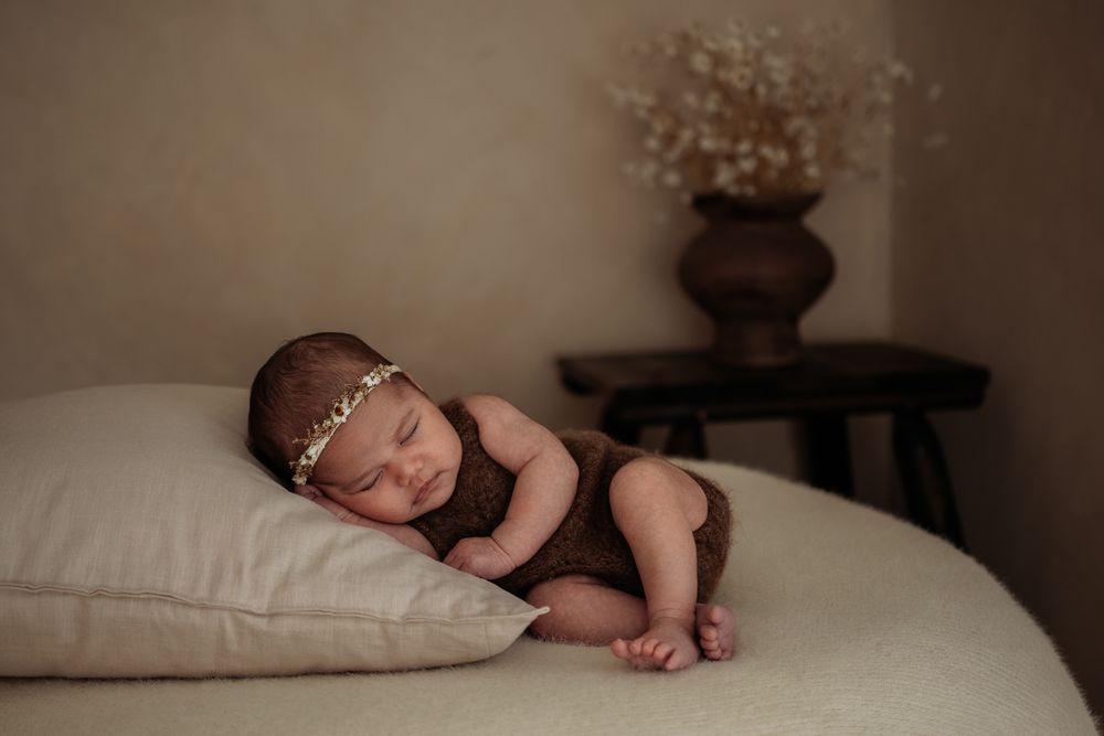 Newborn resting on pillow in Penrith newborn studio