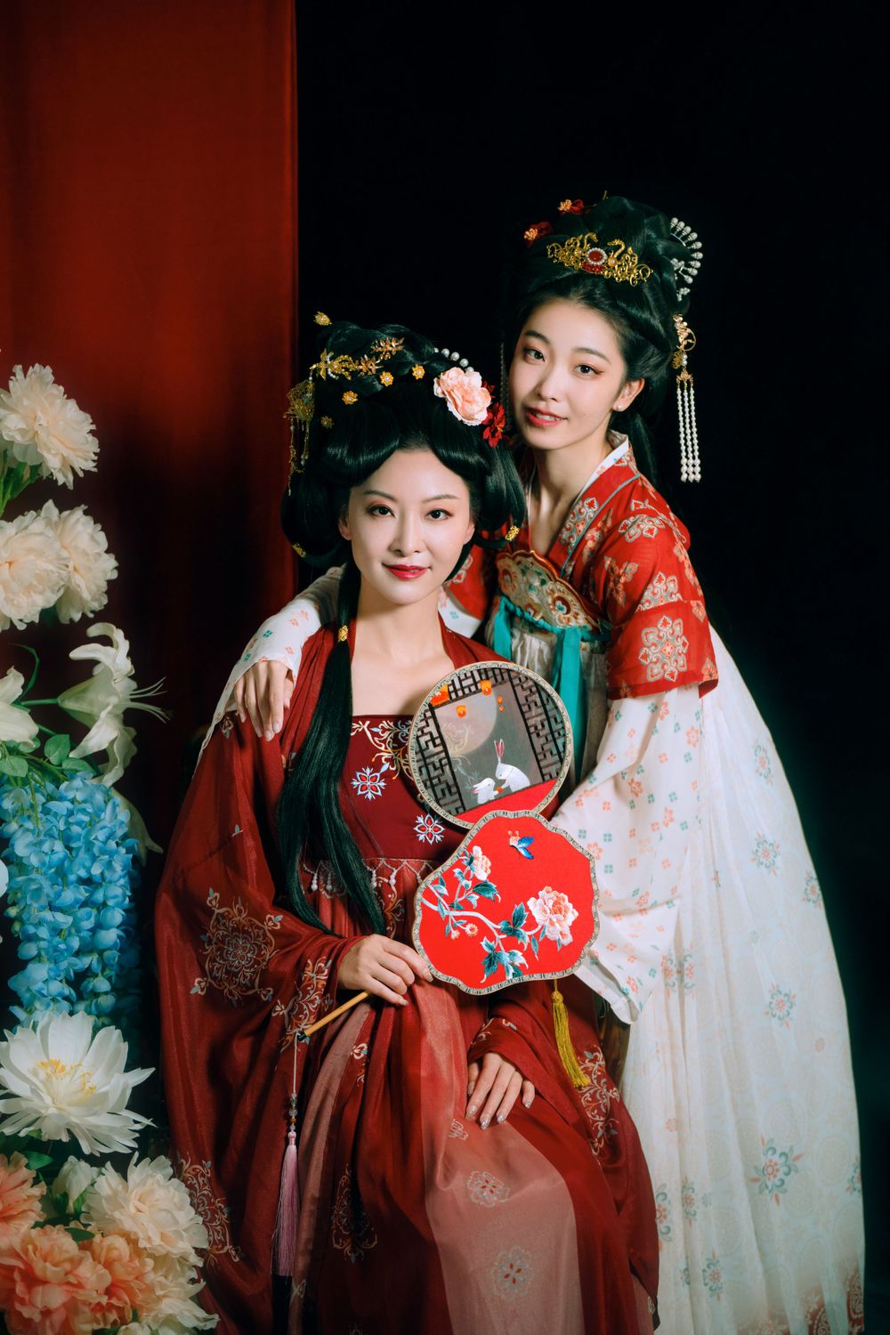 Elegant backlit studio portrait of mother and daughter in Tang Dynasty Hanfu on a swing among wisteria, by Imagine Image Studio.