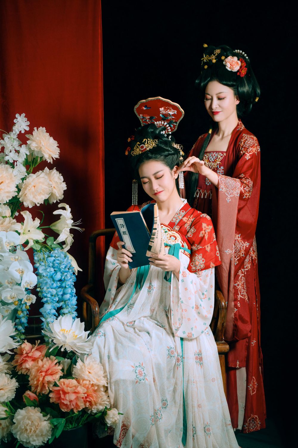 Elegant backlit studio portrait of mother and daughter in Tang Dynasty Hanfu on a swing among wisteria, by Imagine Image Studio.