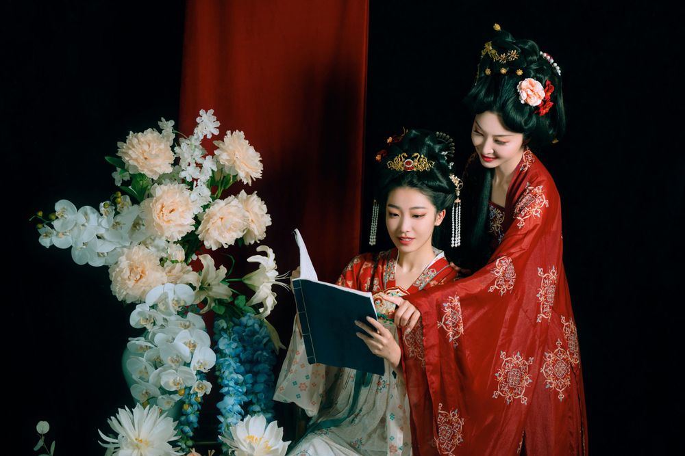 Elegant backlit studio portrait of mother and daughter in Tang Dynasty Hanfu on a swing among wisteria, by Imagine Image Studio.