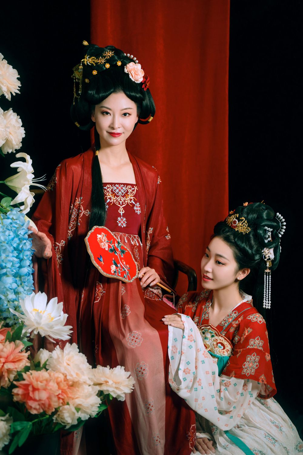 Elegant backlit studio portrait of mother and daughter in Tang Dynasty Hanfu on a swing among wisteria, by Imagine Image Studio.