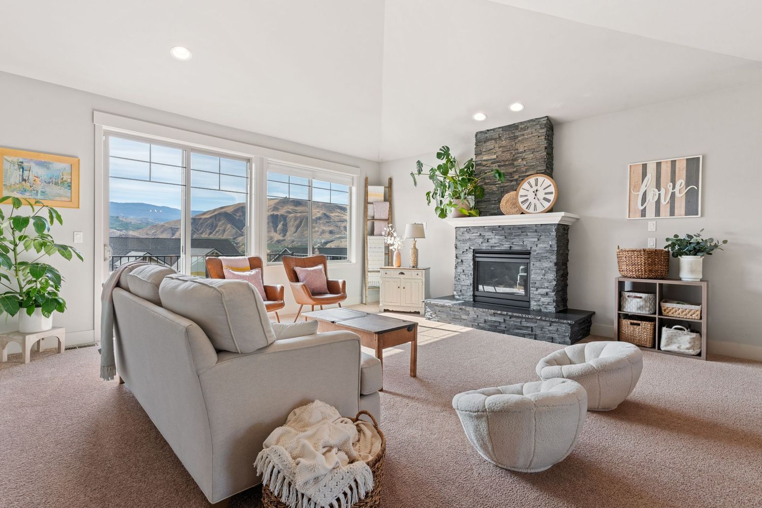 Cozy living room with fireplace, natural light, and spacious layout captured for real estate marketing.
