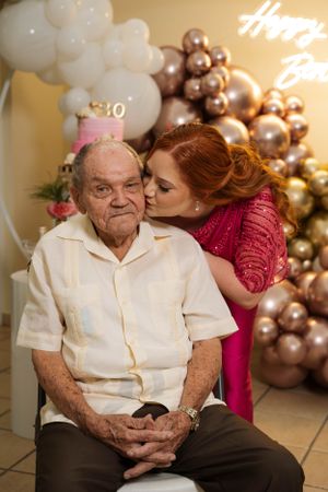 Special moment captured at 30th birthday celebration with balloon decorations and cake display.