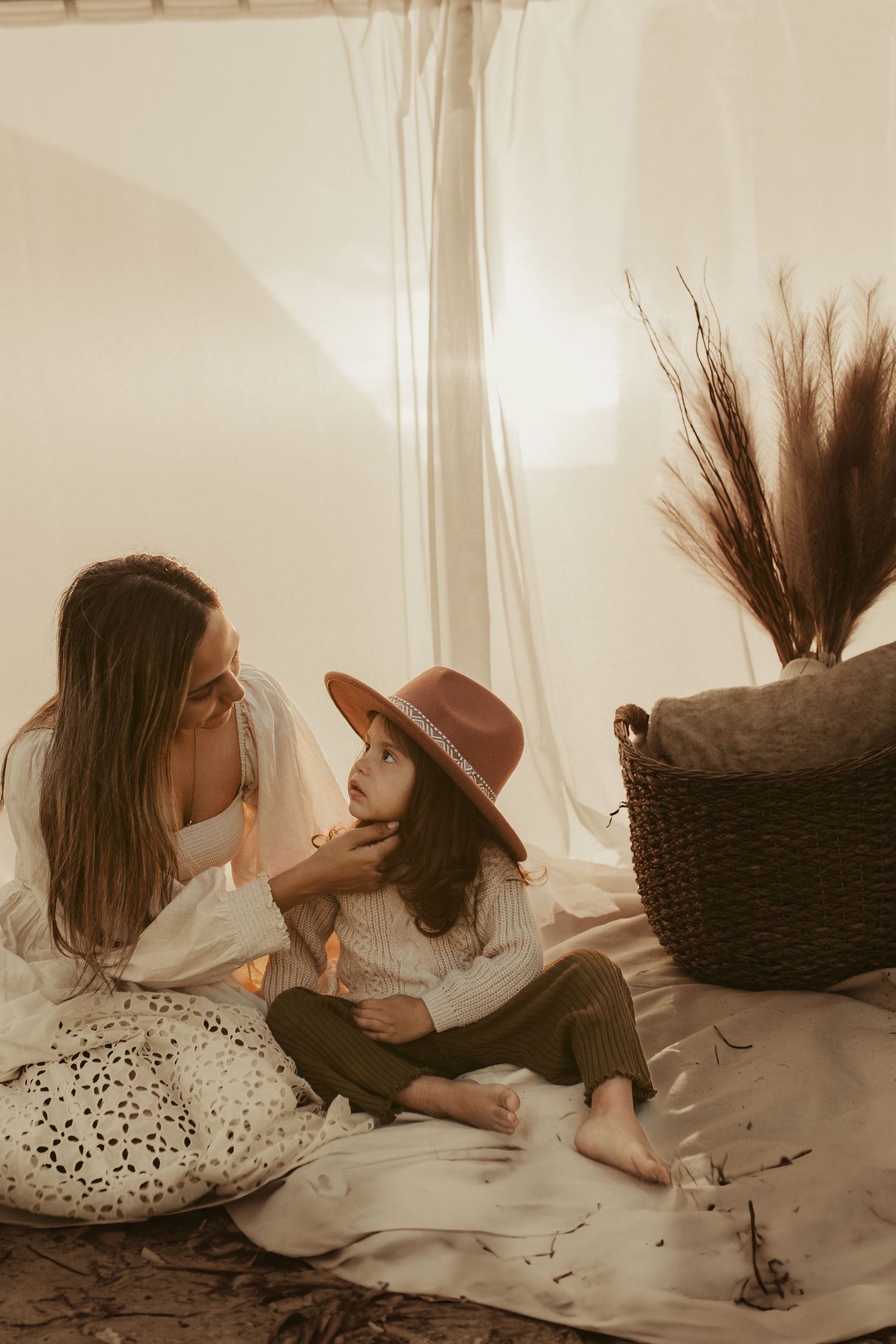 Heartwarming indoor portrait session with boho styling and natural lighting.