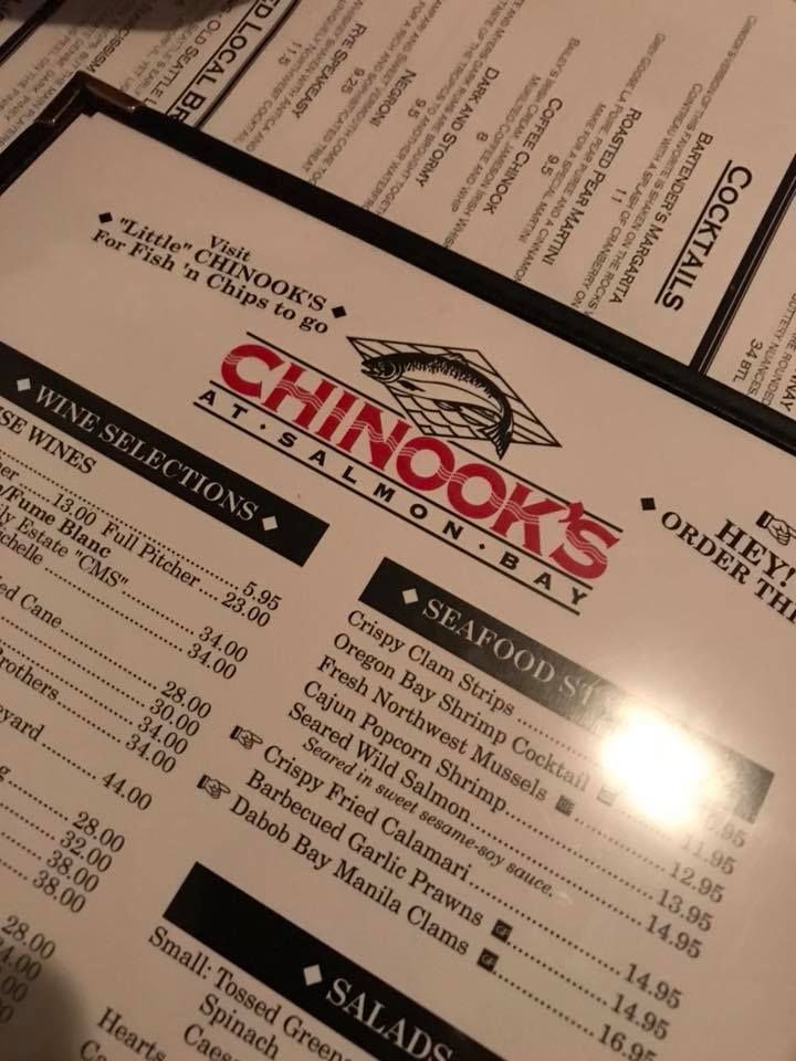 Close-up of a Chinook's restaurant menu showing seafood options.