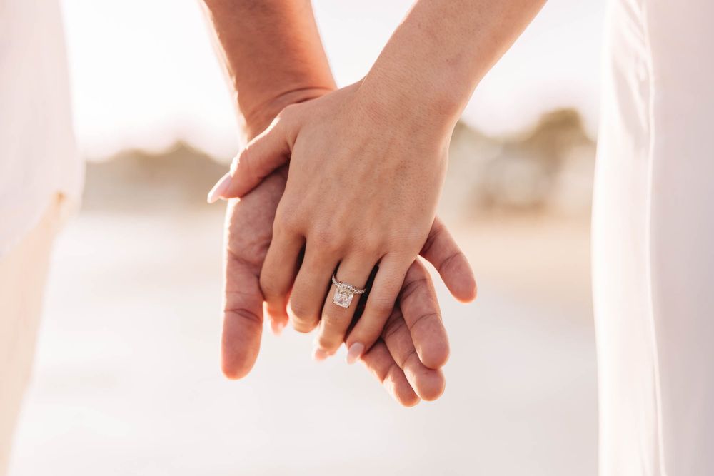 Detail shots of hands with engagement rings against white background.