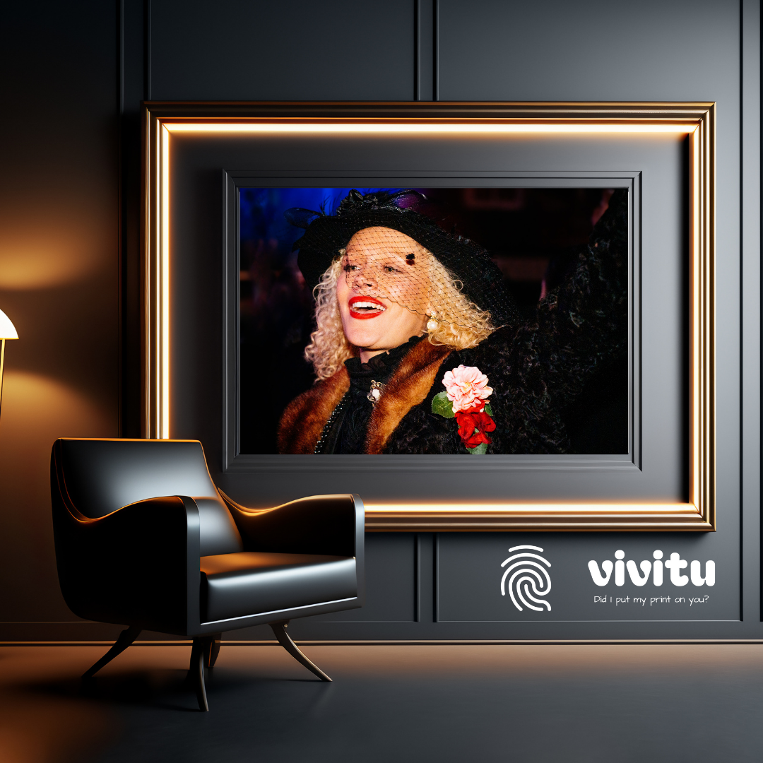 Framed portrait print in a modern setting, illuminated by a spotlight, featuring the Vivitu photo gifts logo.
