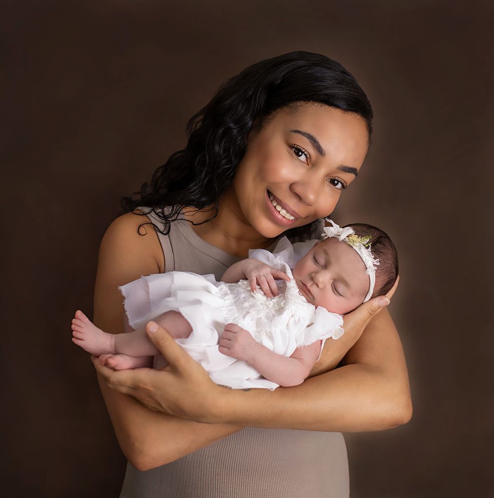 Picture of new mum holding her baby girl in her arms.