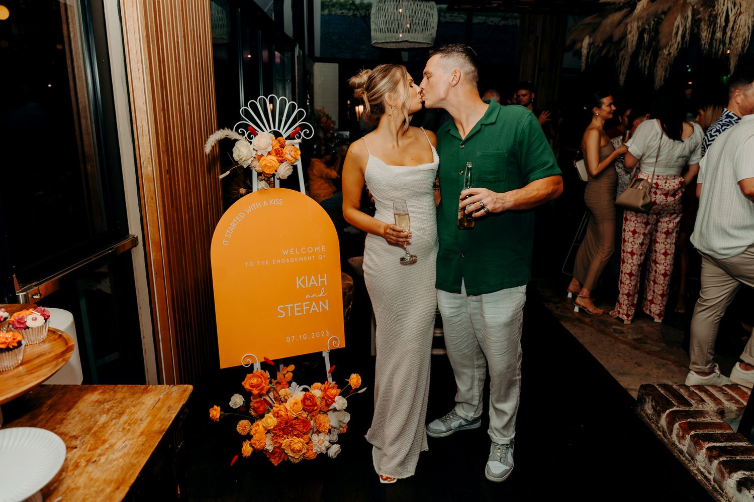 Evening celebration with orange mailbox decoration and floral arrangements.