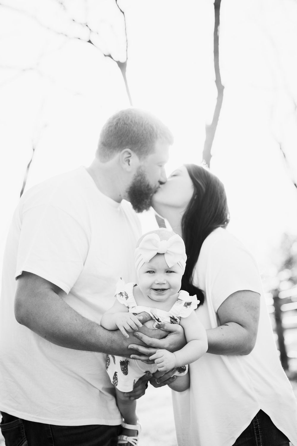Tender family moment captured in black and white photography.