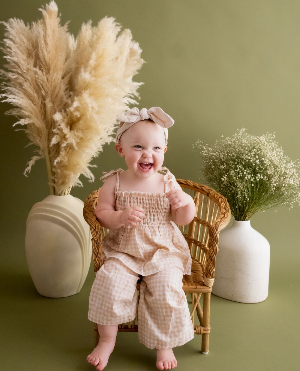 One year old smiling, boho vibes, in studio session.