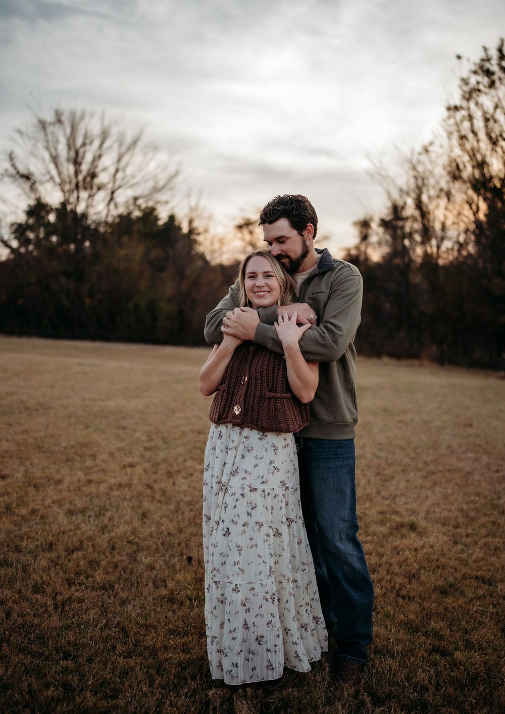 A couple shares an intimate embrace in a golden field at sunset, captured in a series of candid moments.