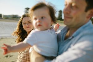 A series of cropped candid family moments showing warm embraces and interactions in natural outdoor lighting.