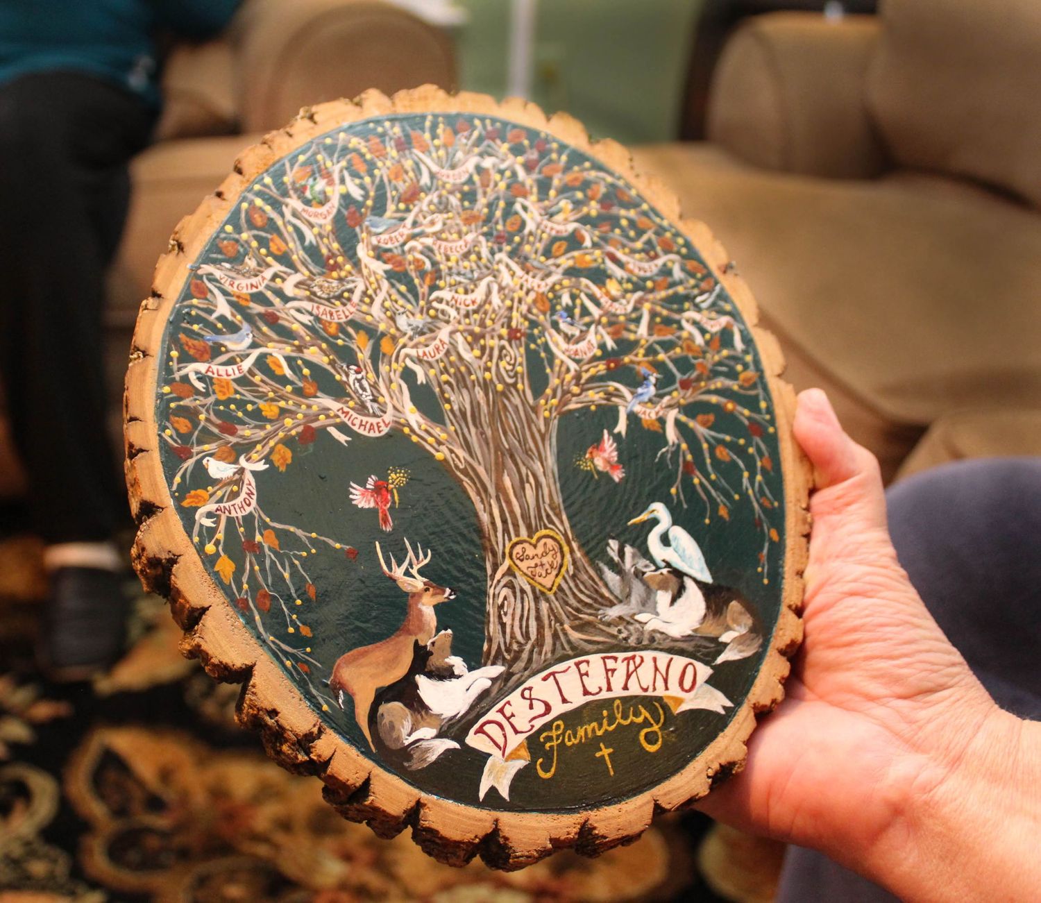 Decorative wooden slice with tree of life design and rustic burning details.