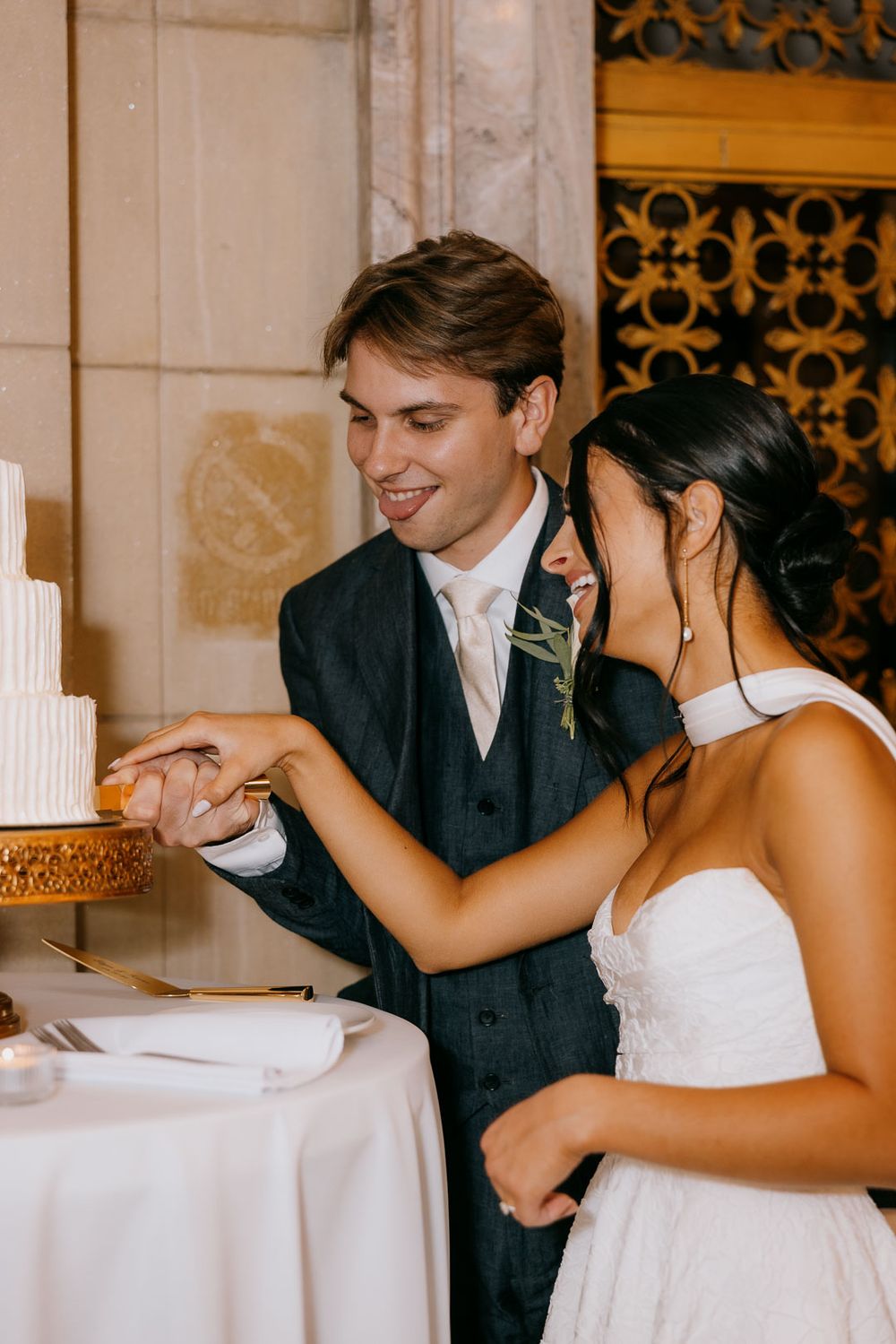 Bride and groom cutting wedding cake, captured by Cleveland wedding photographer.