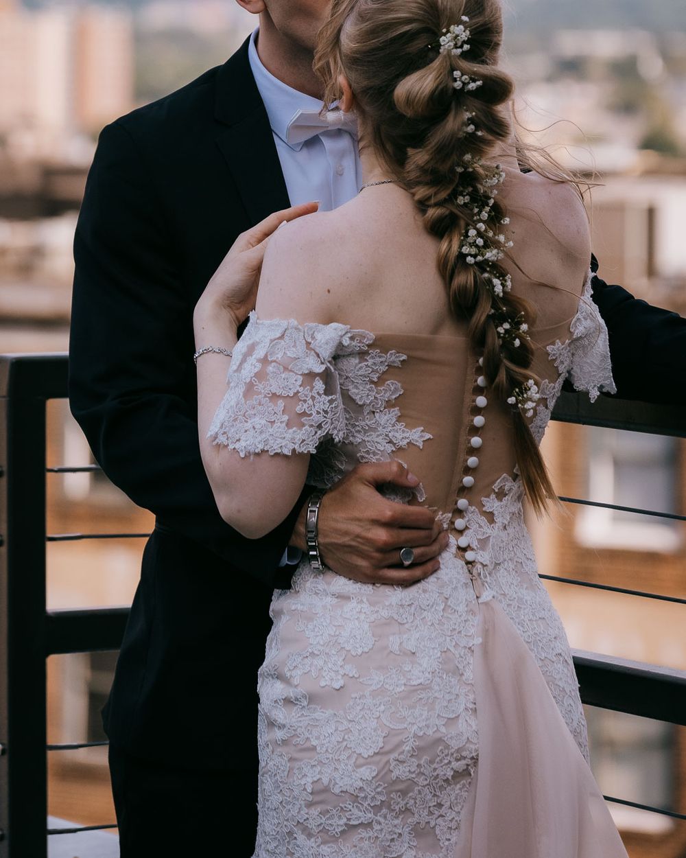 Bride and groom embracing on a city rooftop, captured by Cleveland wedding photographer.