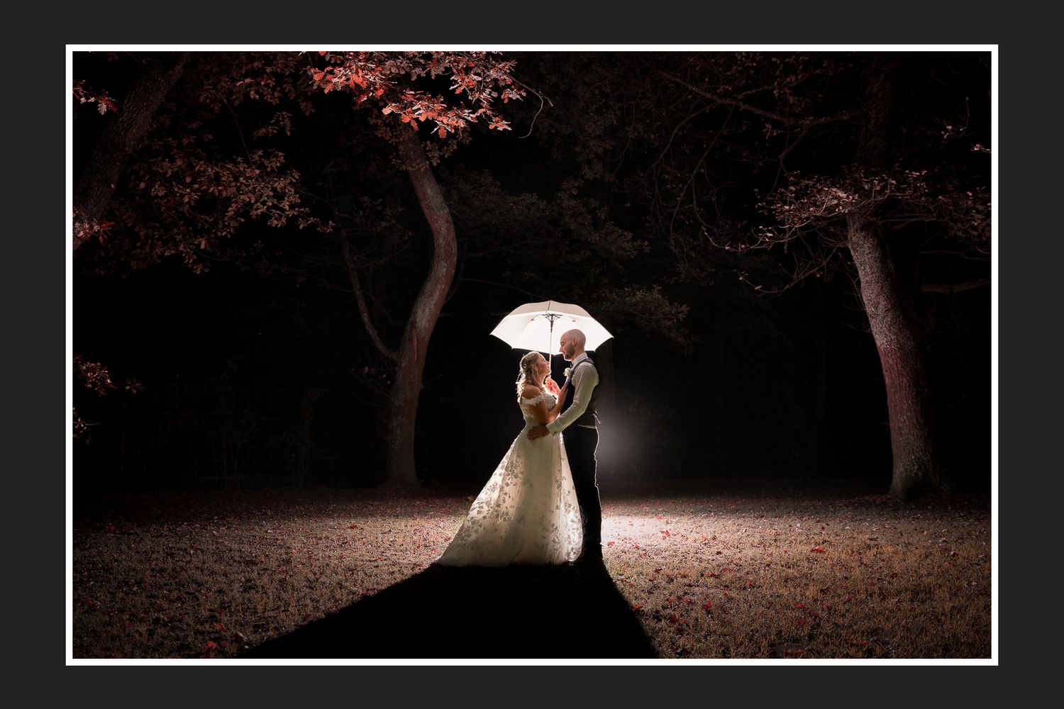 A intimate moment shared between a couple with majestic mountain scenery in the background.