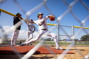 Baseball pitcher captured in sequence of motion during windup and delivery from mound during game.