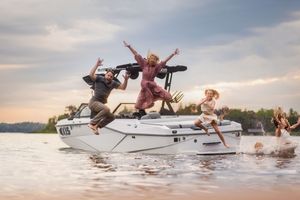 A sequence of action shots showing water skiers performing jumps and tricks on a lake at sunset.