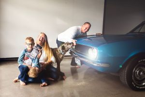 Creative automotive photoshoot setup with dramatic studio lighting and reflections.