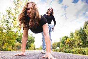 Low-angle action shots of people running across concrete ground outdoors.