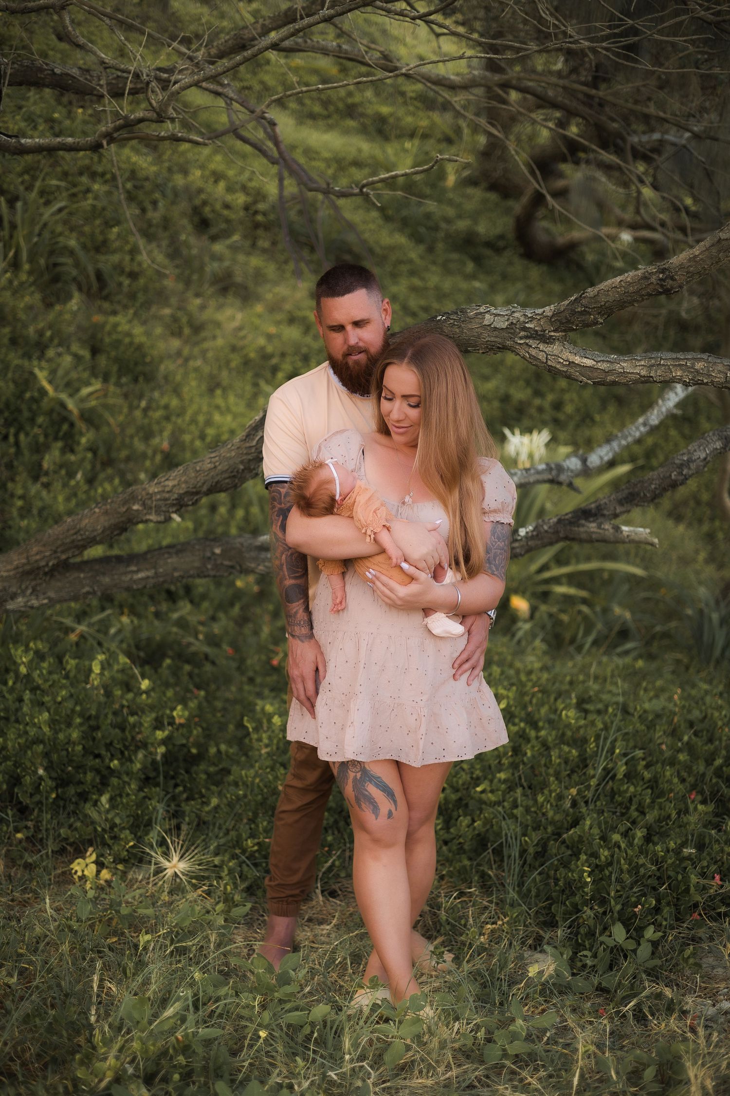 Newborn photoshoot on the beach at the Sunshine Coast with soft greenery in the background, creating a serene and peaceful atmosphere