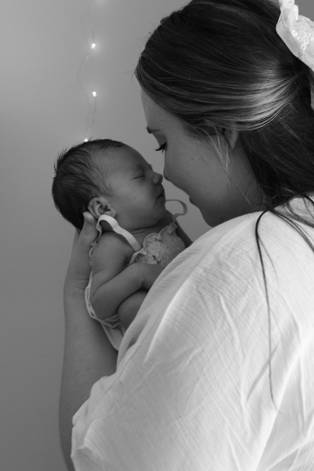 Intimate black and white portrait sequence showing tender parent-child moments.