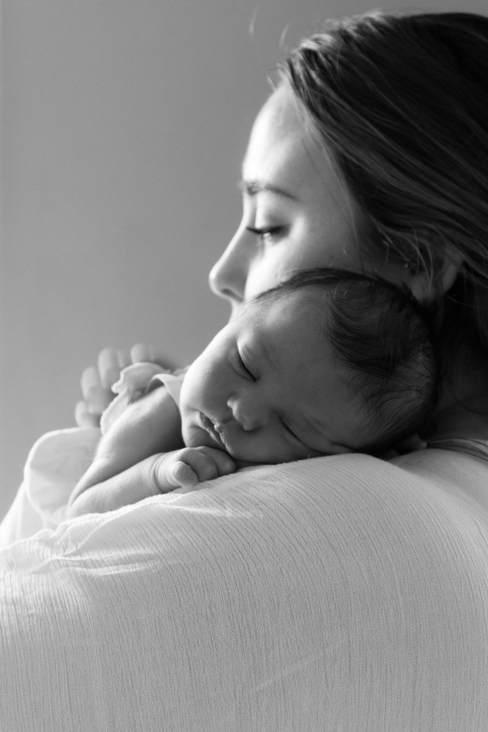 Black and white close-up series showing peaceful sleeping infant.