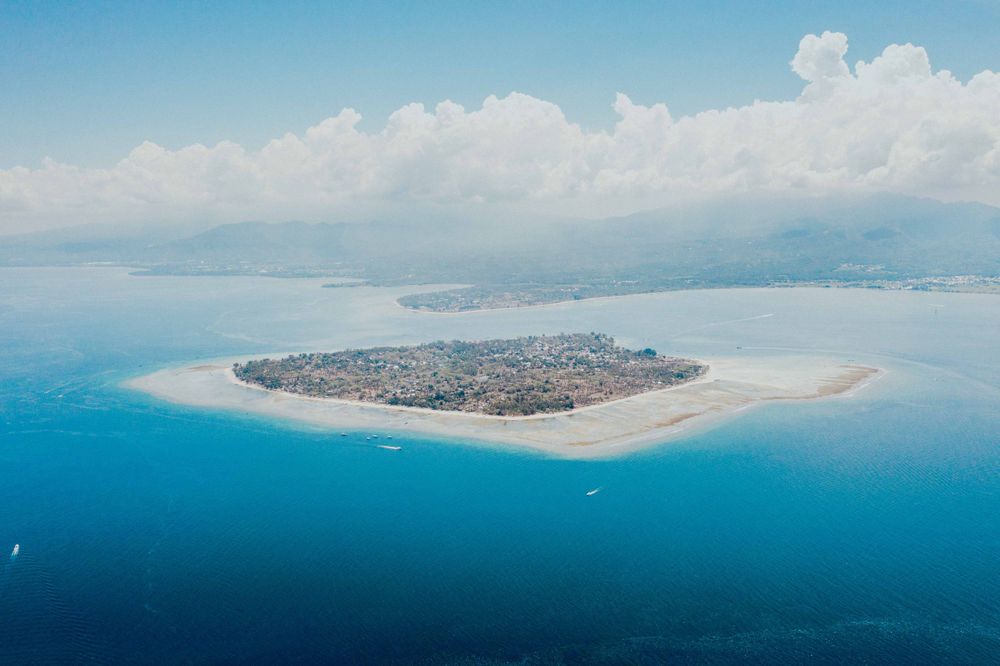 Aerial view of a tropical island paradise surrounded by crystal clear turquoise waters.
