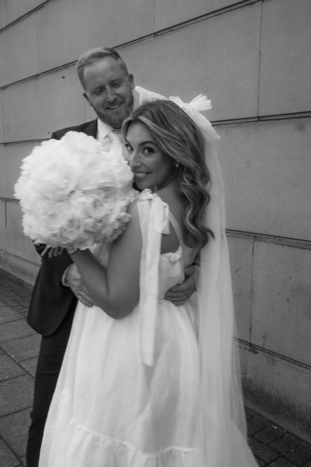 Series of playful wedding photos showing a bride twirling in a white dress with feather details.