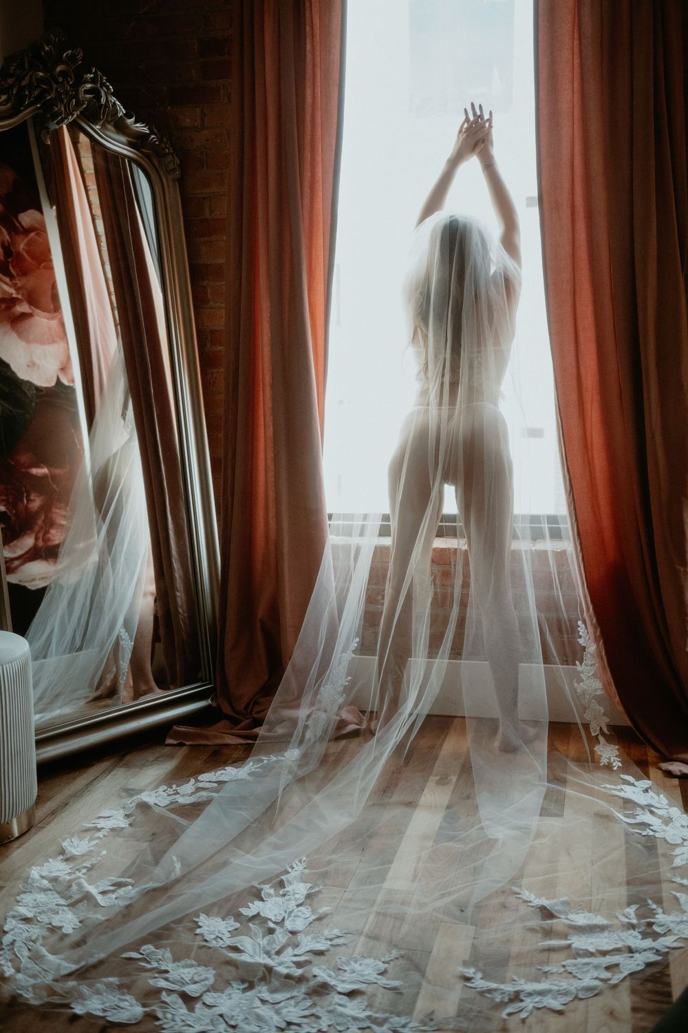 Bridal Boudoir Photoshoot of woman in Lace looking out window.