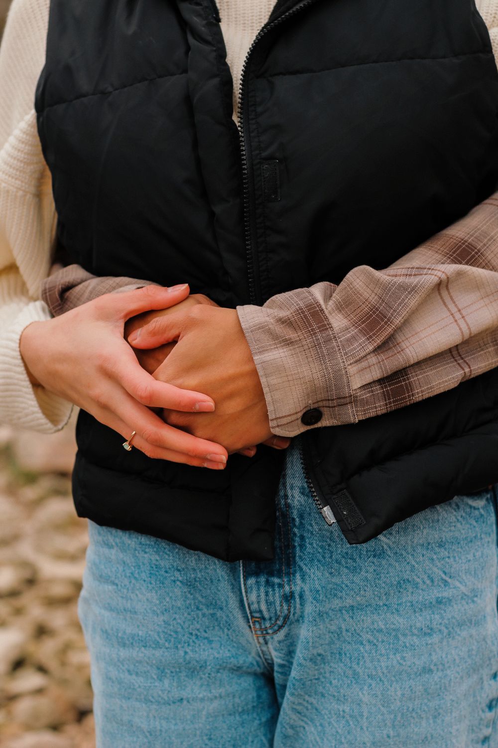 Couples photography of a man hugging a woman from behind with one arm.