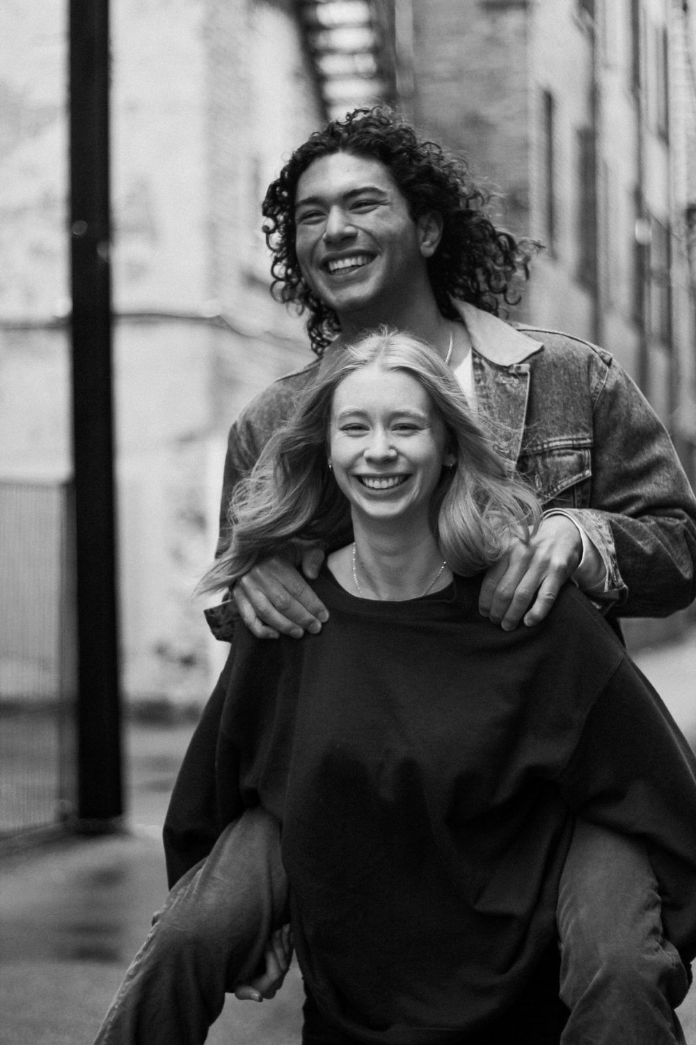 Couples photography of a woman giving a man a piggy-back ride.