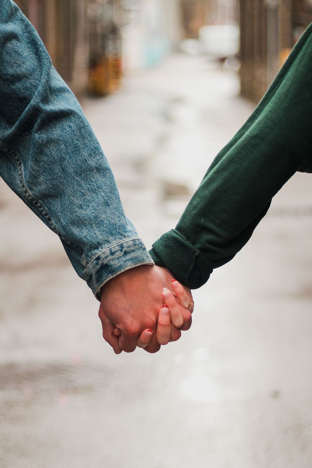 Couples photography of the man's hand and woman's hand holding each other.