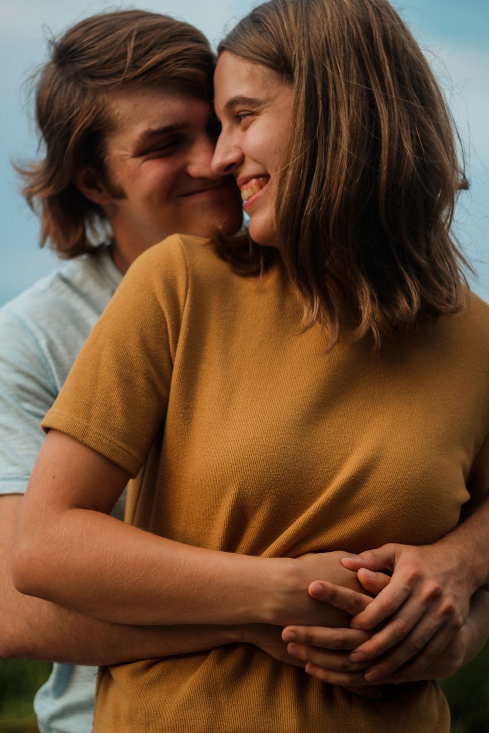 Couples photography with man hugging the woman from behind.