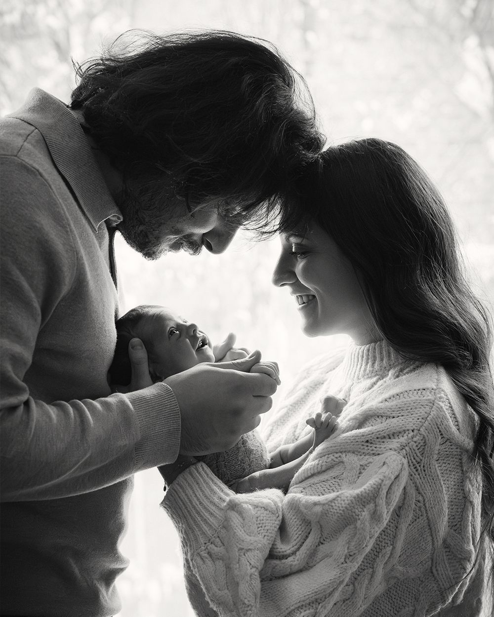 A romantic black and white photo series showing a couple in intimate close-up poses against a light background.
