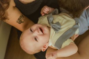 Parent showing affection to baby in candid moment.