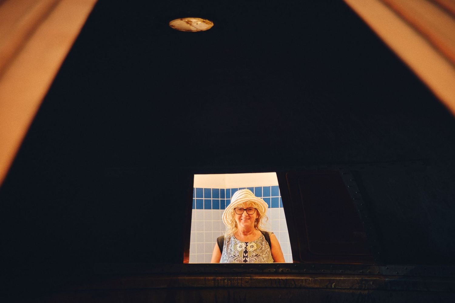 View through a small window opening in an interior space.