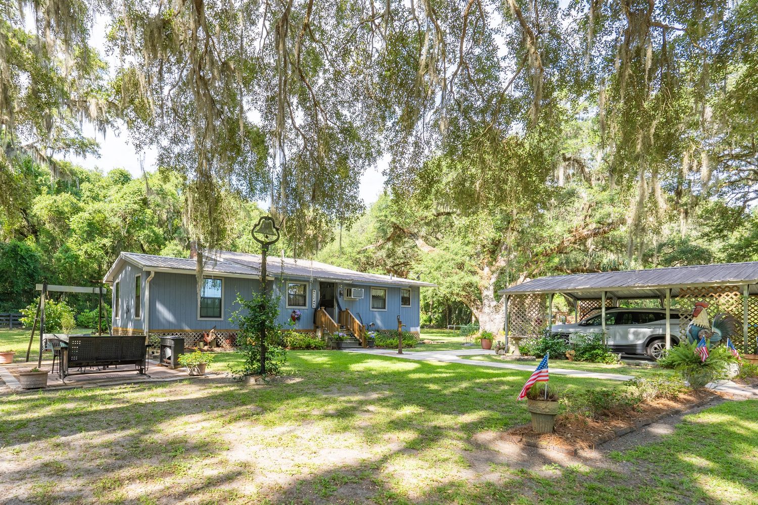 Florida cracker house in the country with shade trees all around.