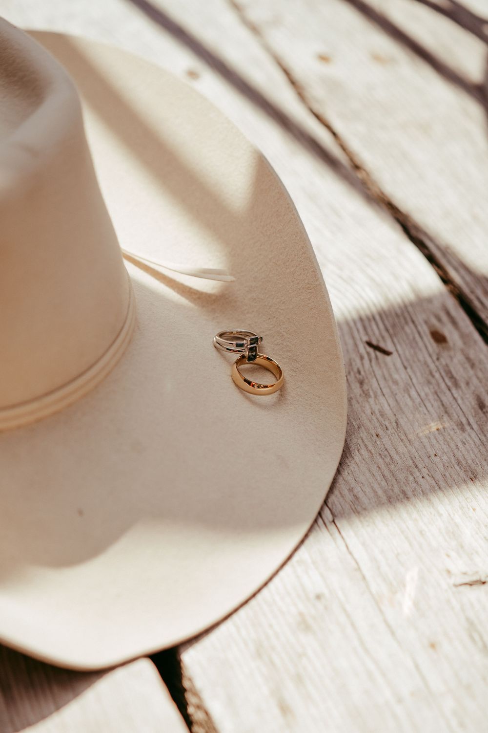 romantic western wedding portrait of a bride and groom embracing at sunset in the mountains