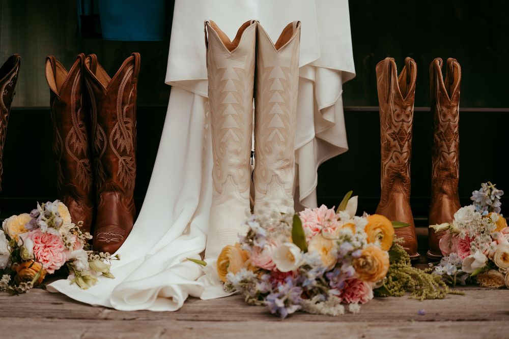 romantic western wedding portrait of a bride and groom embracing at sunset in the mountains