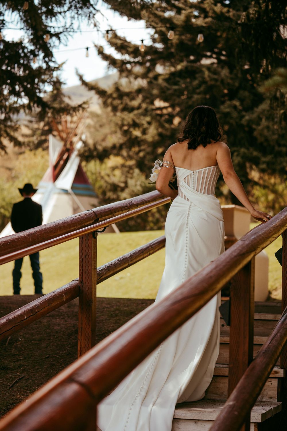 romantic western wedding portrait of a bride and groom embracing at sunset in the mountains
