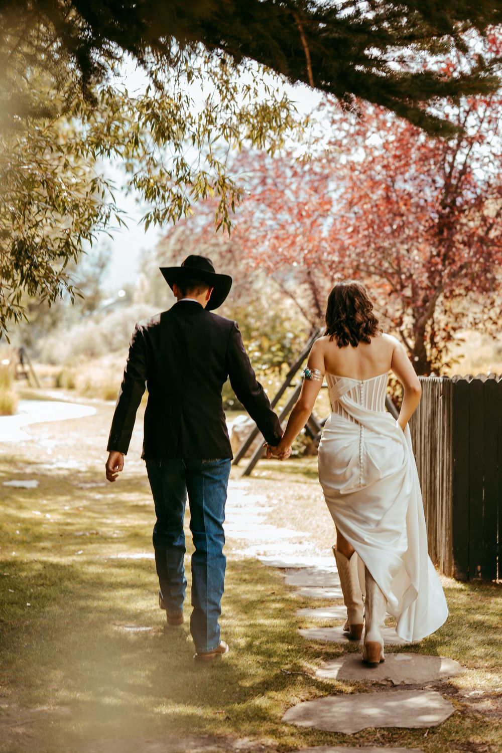 romantic western wedding portrait of a bride and groom embracing at sunset in the mountains