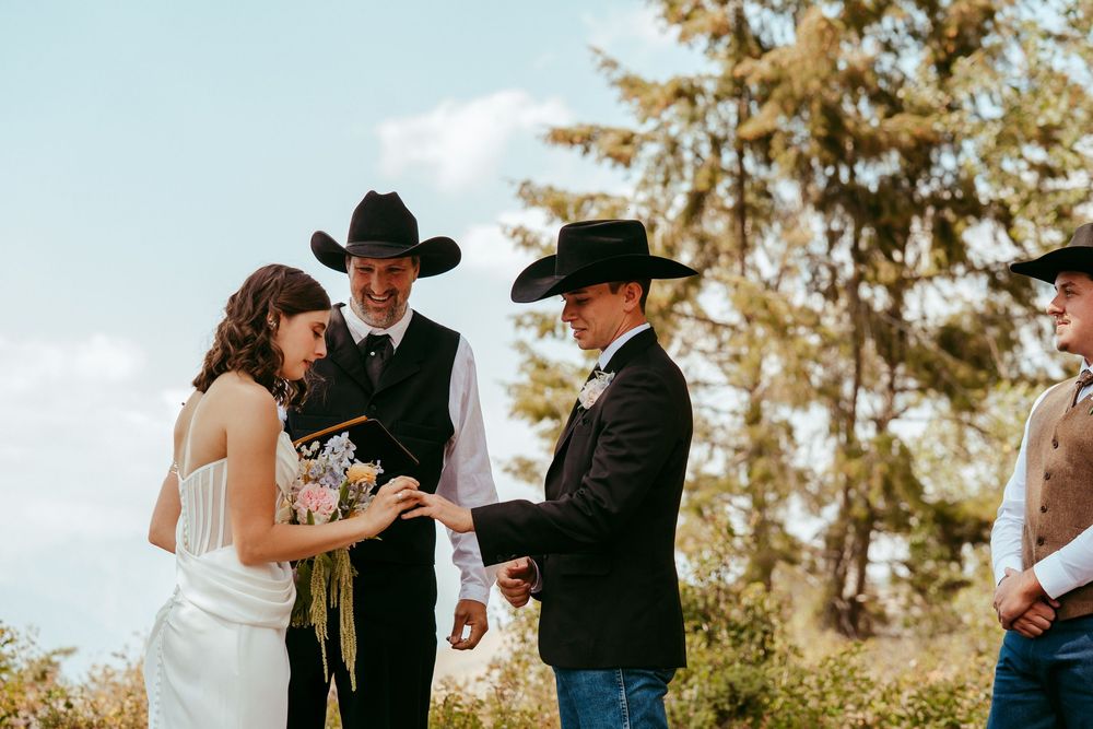 romantic western wedding portrait of a bride and groom embracing at sunset in the mountains