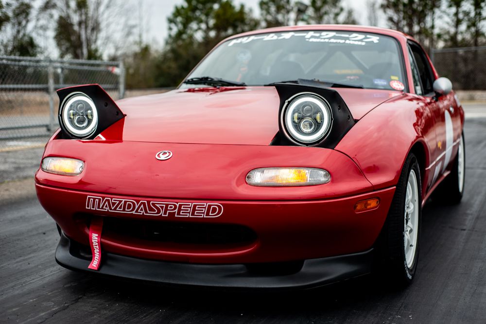 Classic red Honda NSX sports car shown from multiple angles displaying its iconic 1990s design and distinctive pop-up headlights.