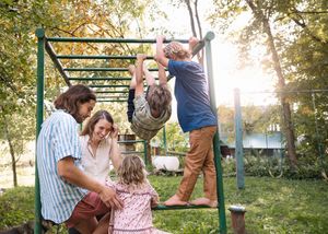 A series of five outdoor photos showing joyful moments between people on a playground swing set at sunset.