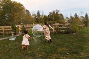 A series of playful moments captured on a grassy hillside with soap bubbles floating in the golden autumn light.