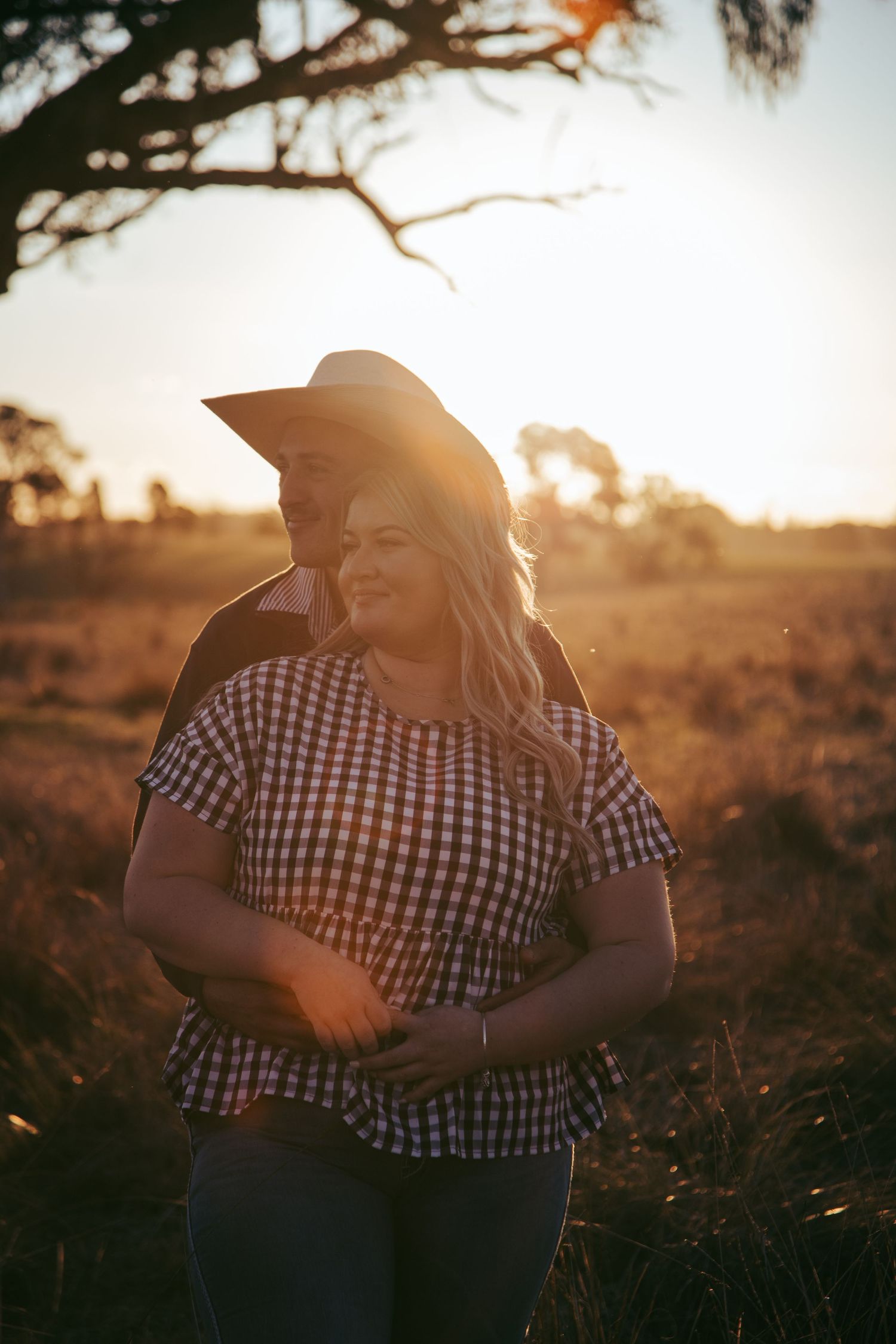 Sunset portrait session in a field with warm golden lighting.