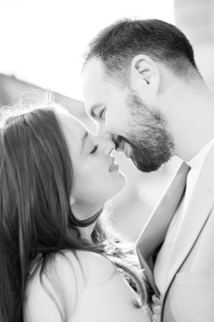 Black and white close-up of couple nearly kissing, showcasing intimate romantic connection during engagement session.
