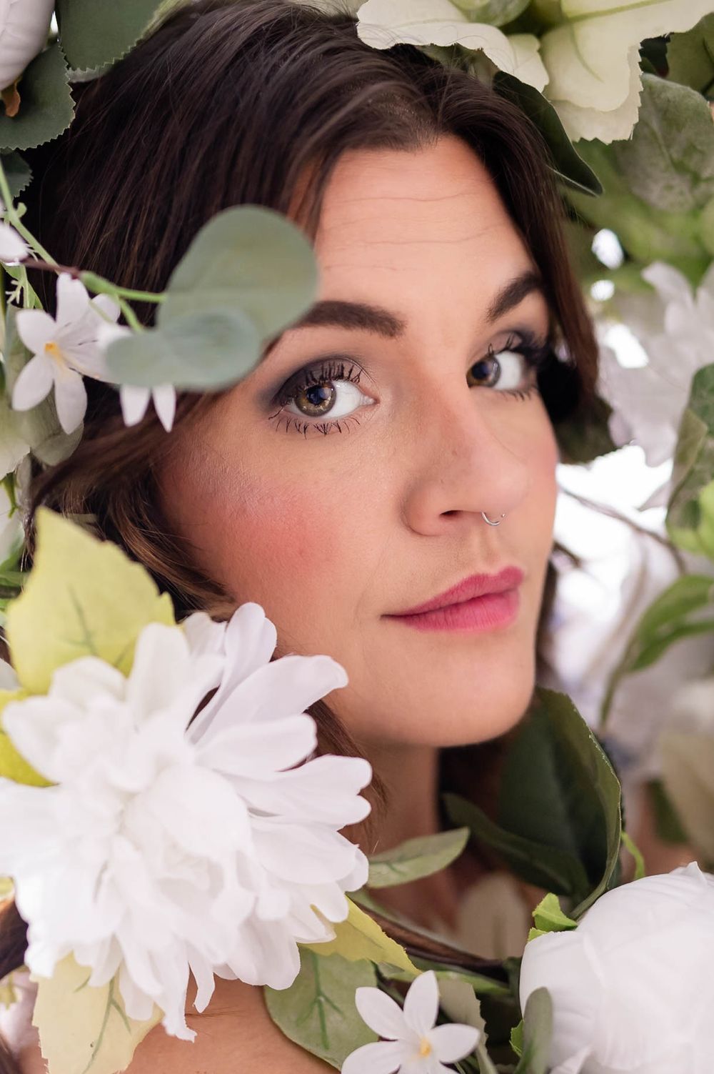 Fine art portrait of a woman framed by flowers during a studio session in Mountain Home, Arkansas